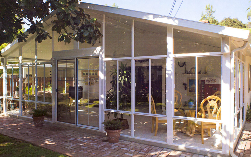A sunroom attached to a house is shown like the type Mico Construction of Fresno, CA builds.